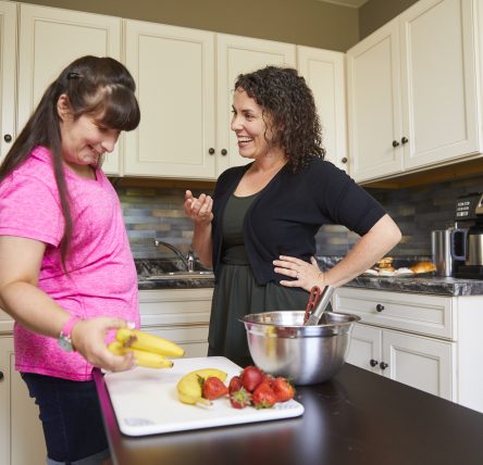 Female client and female staff member in kitchen