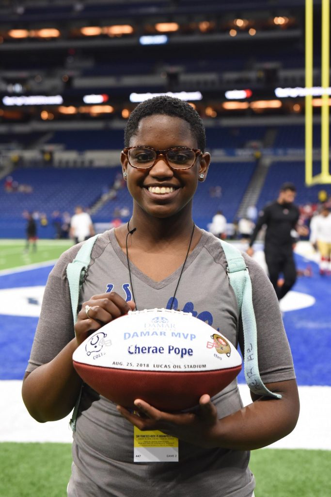 Cherae holding football at Colts game