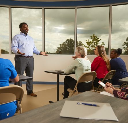 Male staffer member conducting a training