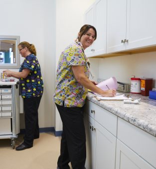 female staff member working and smiling