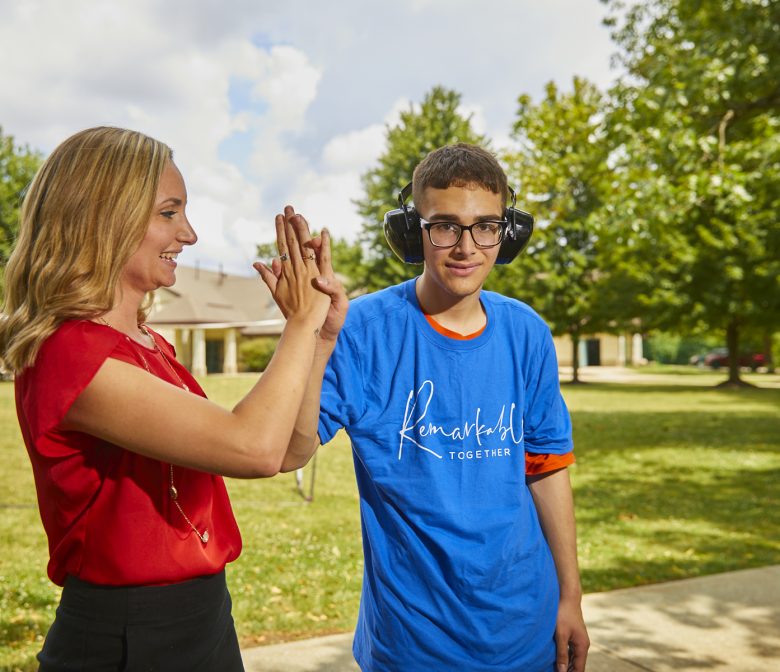 Female Staff member high fives male client