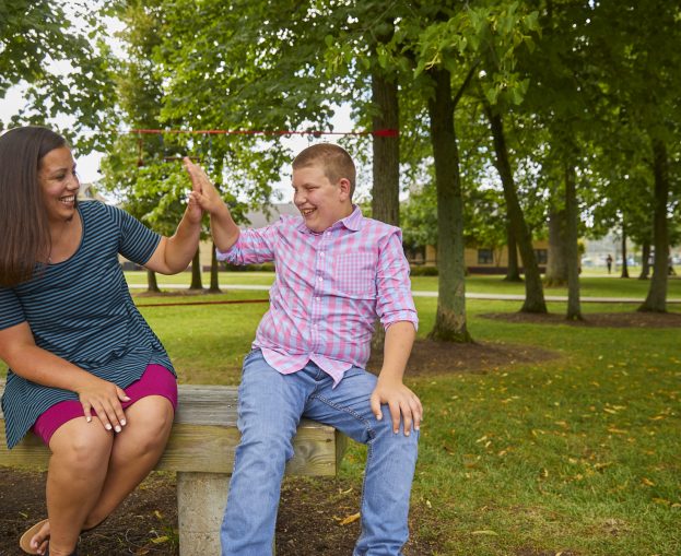 woman staff member and male client high-fiving