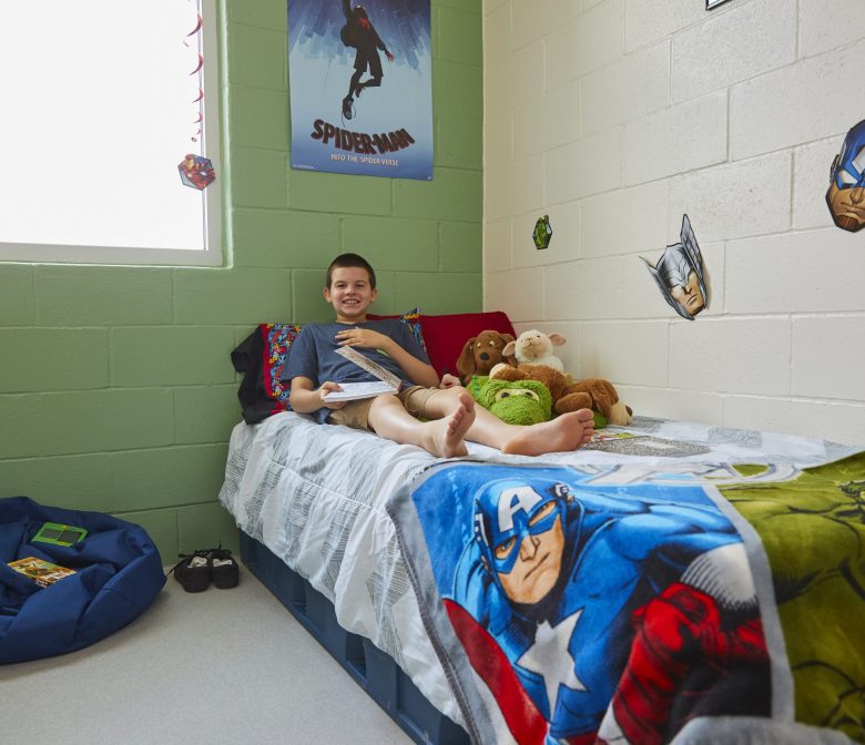 Young male client lounging on bed