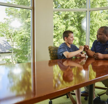 Young male client talking with male staff member