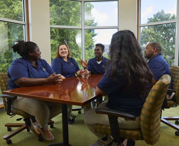 Employees meeting around table