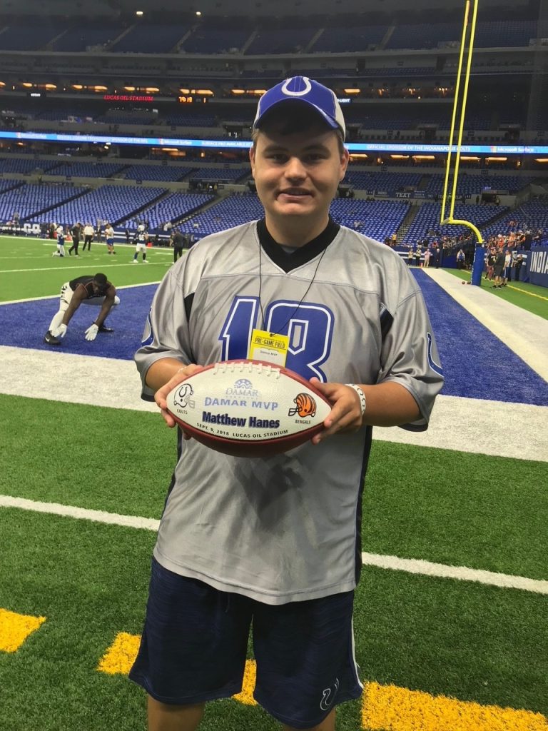 Matthew holding a football