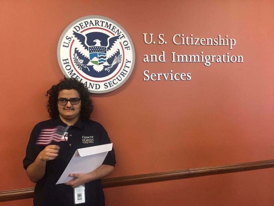 Mihaela holding her certificate of Citizenship