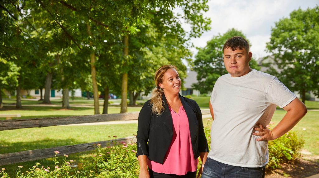 woman staff member and male client smiling