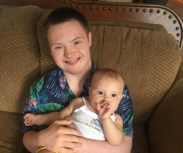 Grandson holding baby