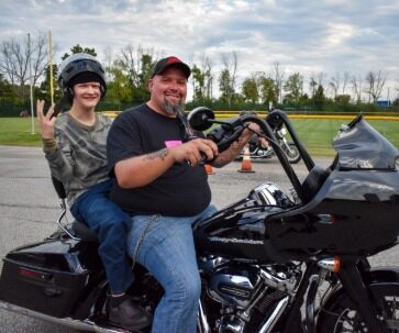 Damar client with parent on a motorcycle