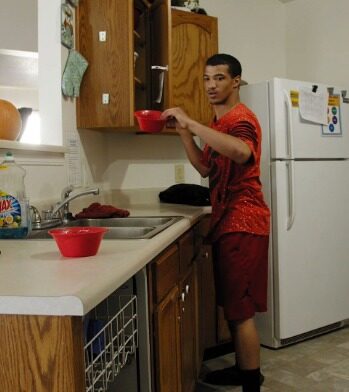 Marcus putting away dishes