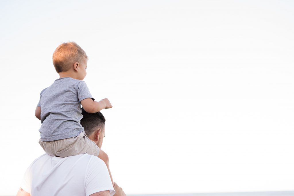 child on dad's shoulders