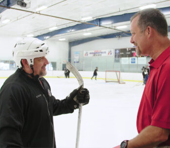 Steve talking with other male at ice rink