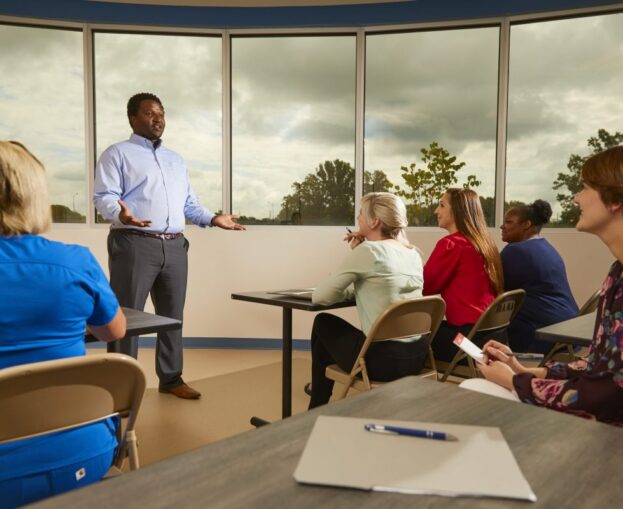 Male instructor speaking to class