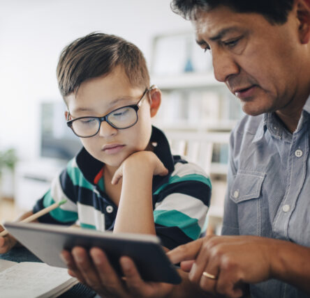 Father and son doing school work