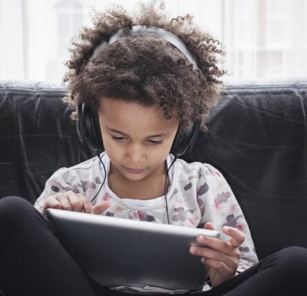 Girl using tablet with headphones