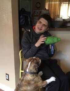 Jacob sitting with a dog