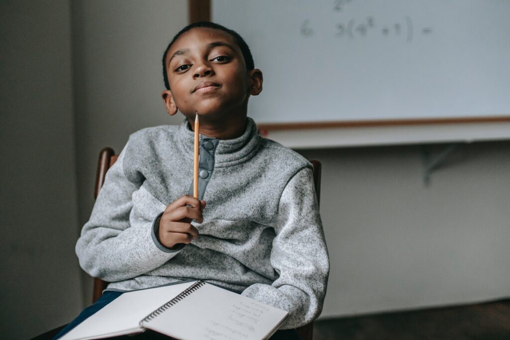 African American boy holding a pencil