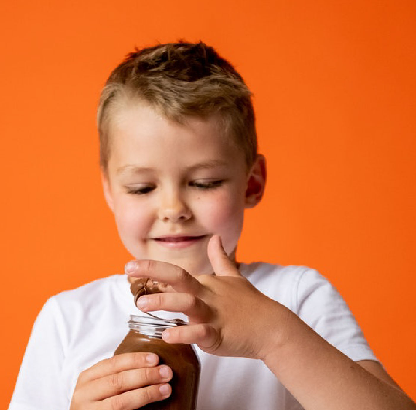 Little boy eating chocolate