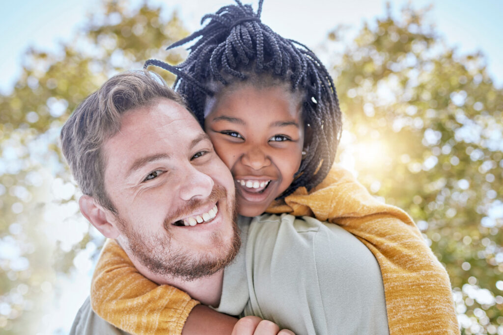 Foster dad smiling with child