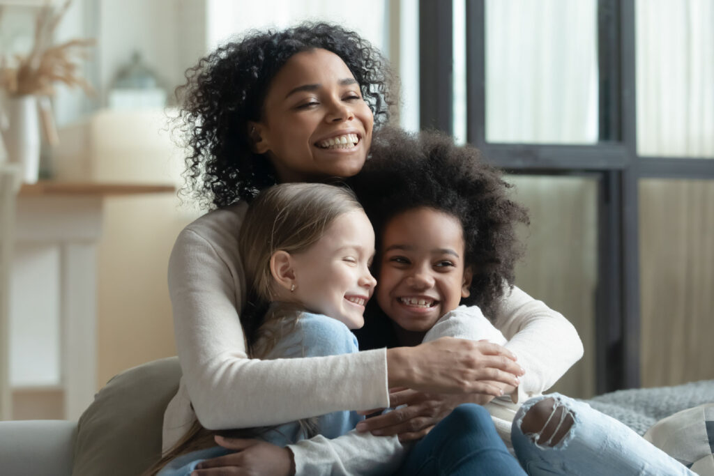 Foster mom hugging children