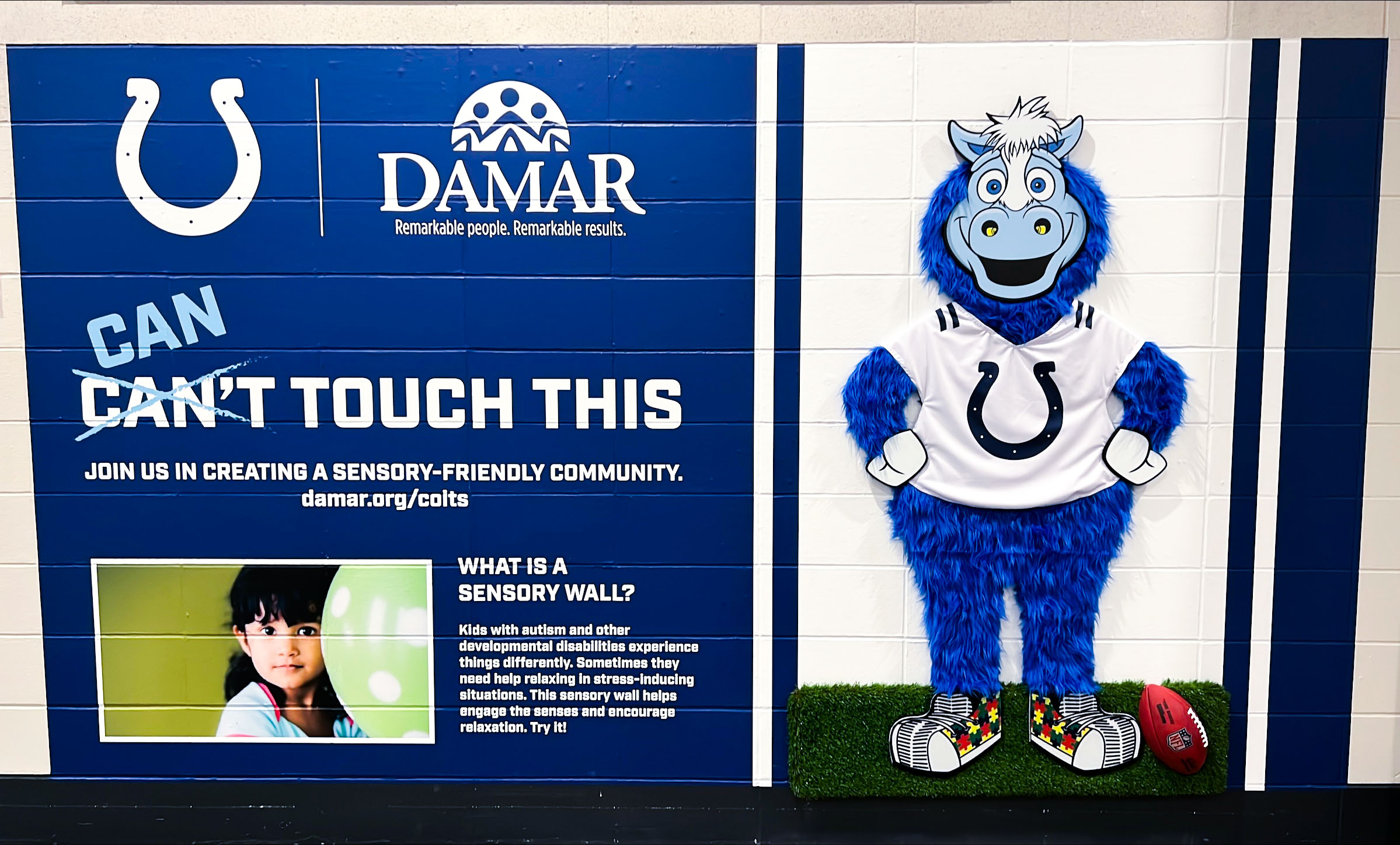 child touching sensory wall
