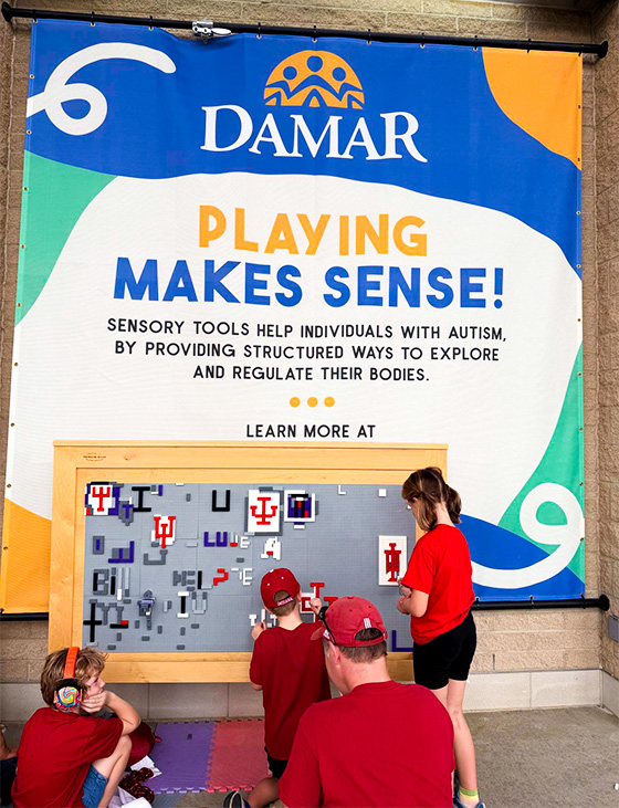 child touching sensory wall