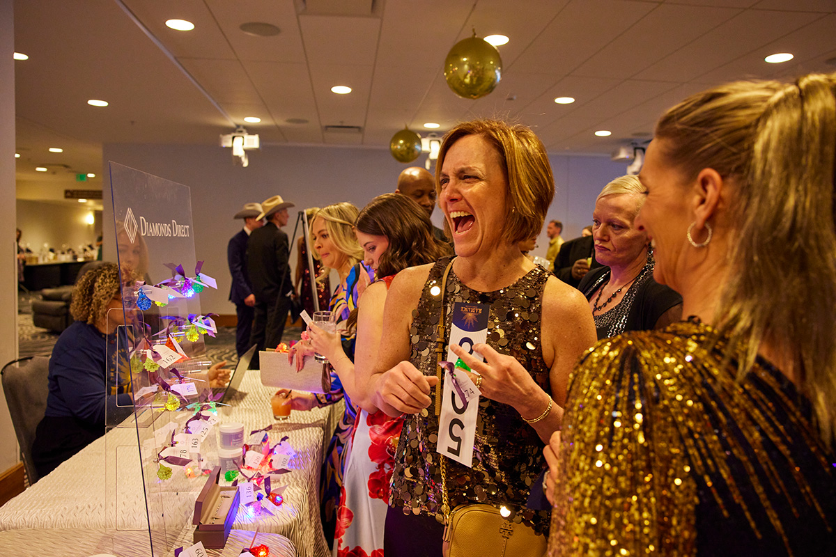 Guests enjoying the auction experience at a past Damar gala