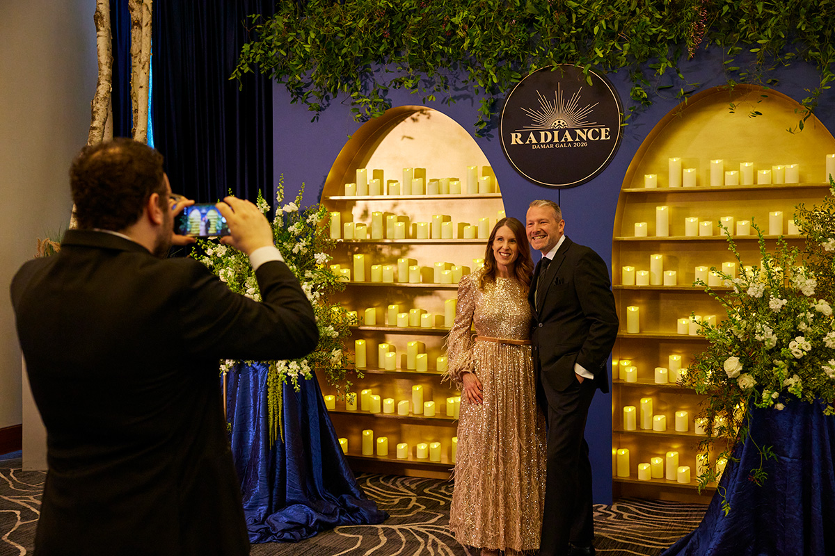 Guests posing for a photo at a past Damar gala