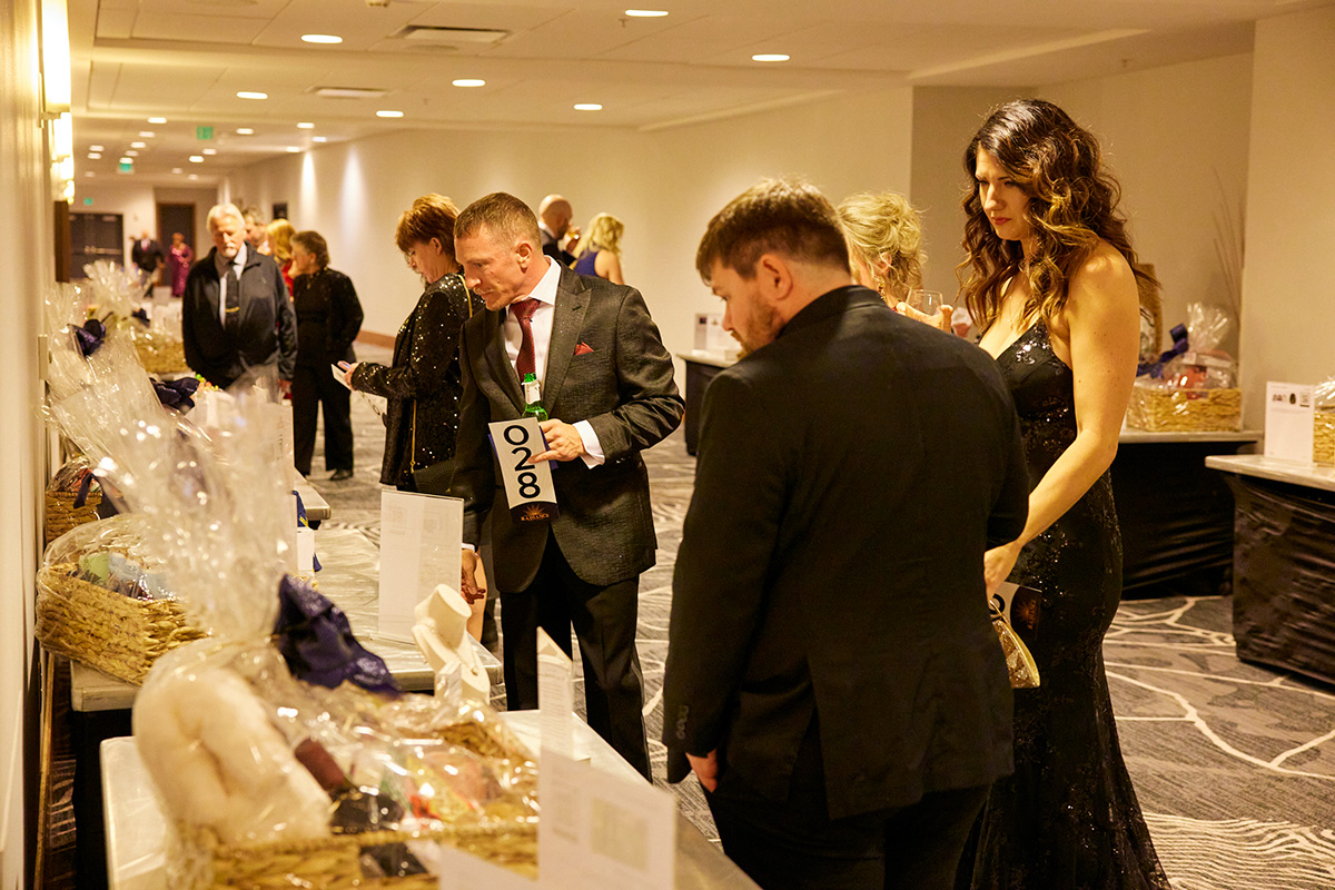 Guests browsing auction items at a past Damar gala